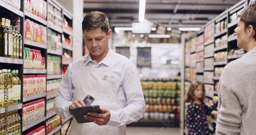 Supermarket, tablet and man with scanner for stock list, customer welcome and sales report. Digital tech, inventory and manager in grocery store for quality control, price check and retail management