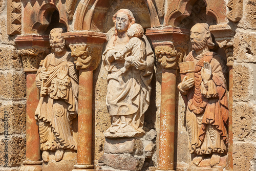 Chapel facade sculptures detail Santa Maria de Piasca. Cantabria, Spain