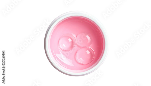 Top-down view pink gel in white jar with three clear liquid droplets