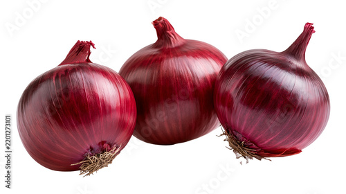 Three fresh whole red onions with papery skin and fibrous roots