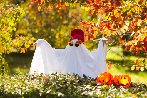 kid in Halloween ghost costumes  in the park. Halloween party