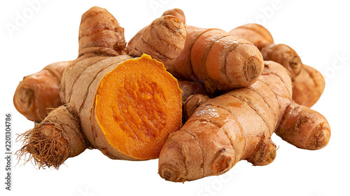 Fresh raw turmeric root with one piece sliced showing vibrant orange interior