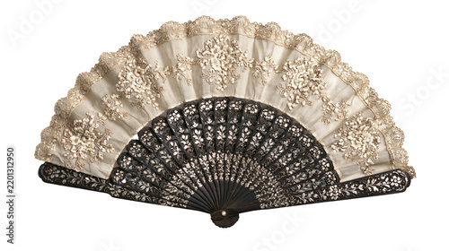 Fotografie Vintage folding hand fan with dark carved wooden frame and cream lace fabric