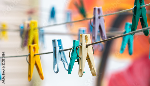 Colorful Plastic Clothespins On A Line With Abstract Orange Background