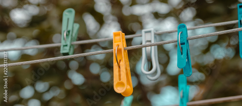 Orange Clothespin With Green And Grey Pegs On A Clothesline Outdoors
