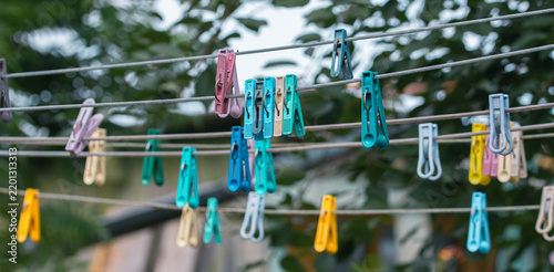 Many Different Colored Clothespins Hanging On Wires In The Garden