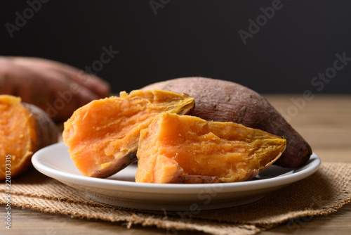 Steamed orange sweet potatoes on white plate ready to eat, healthy food
