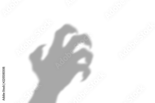 A dark scary shadow of a clawed hand reaching out in a menacing gesture representing fear and horror isolated on isolated on transparent background