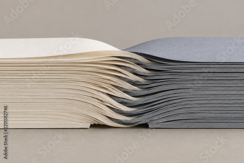 Cream and gray paper stacks interleaved in soft waves