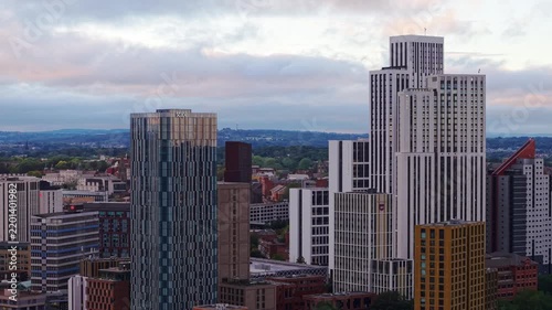 Ambient drone exploration of Leeds, West Yorkshire, England, United Kingdom. Aerial POV of Central City infrastructure, skyscrapers, old town buildings, river and transport in sunset, golden hour.