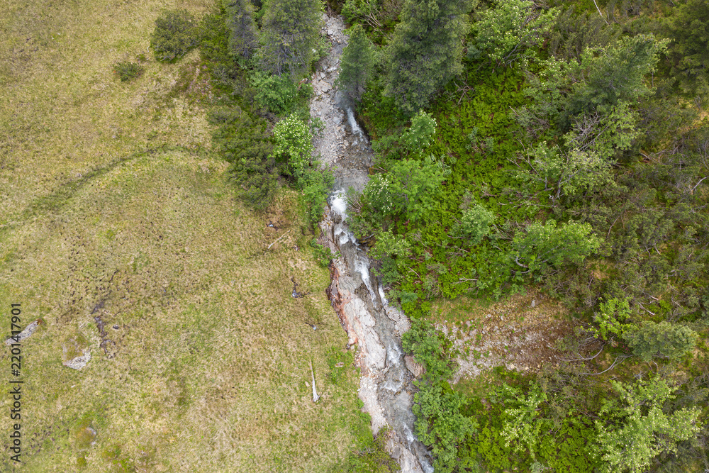 Obraz premium Alpine wilderness and nature conservation, aerial view of a mountain stream flowing through the Kitzbühel Alps in the Hohe Tauern National Park in austria