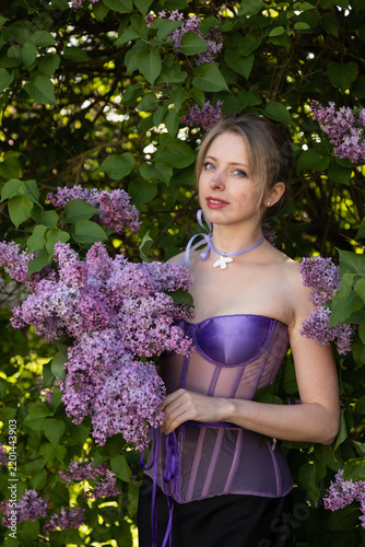 Artistic portrait with lilac blossoms and soft focus botanical background