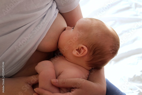 Принти на полотні Mother breastfeeding baby at home