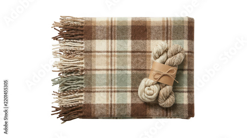 A cozy plaid wool blanket folded with two skeins of yarn isolated on transparent background
