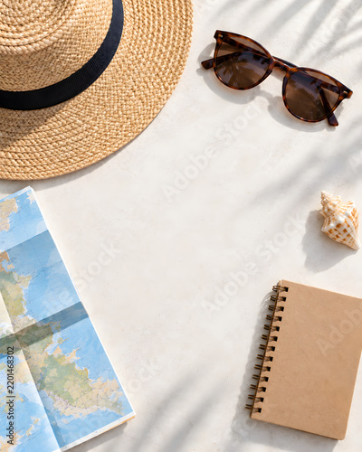 Summer travel flat lay with straw hat, sunglasses and blank copy space