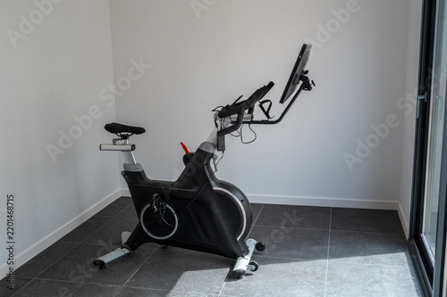 Exercise bike with screen in a modern home gym