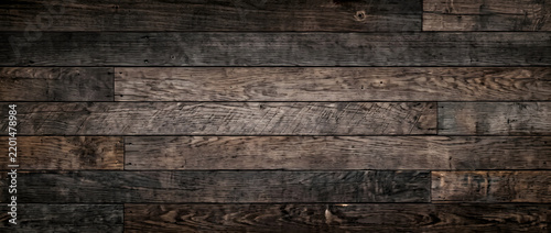 Reclaimed barn wood plank wall texture with dark weathered grain and rustic knots forming a distressed vintage background for design