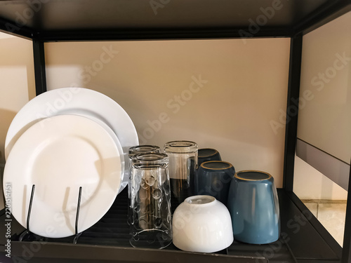 Canvastavla Hotel or restaurant tableware arranged on a serving tray, featuring plates, drinking glasses and ceramic cups
