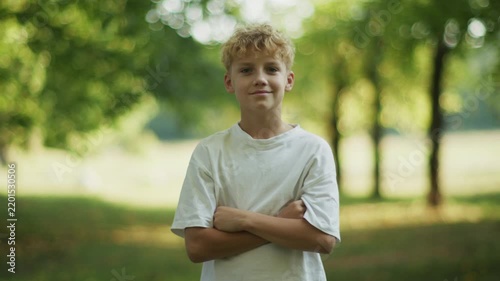 Portrait of Curly 10 Year Old Boy Standing in Park