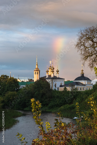 Canvastavla historic suzdal monastery with golden domes and bright rainbow inspires travel across russia