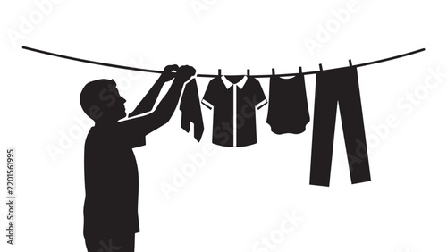 Person's silhouette hanging laundry on a clothesline outdoors with shirts and pants drying in the open air.