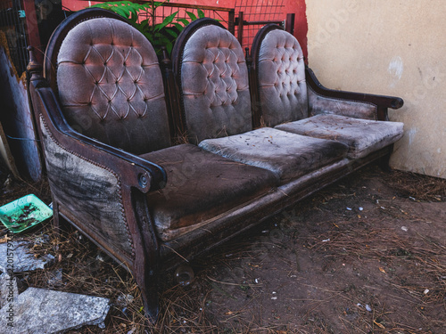 Obraz na plátne Worn vintage armchair discarded in a scrap yard