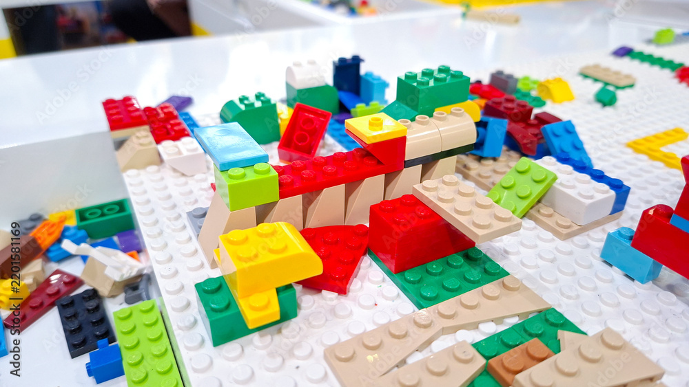 Obraz premium Colorful lego plastic interlocking building blocks and toy bricks constructed on a white baseplate during children play activity on September 22, 2026 in Bangkok, Thailand.