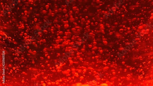 Close Up of Floating Red Bubbles in Lava Lamp, Vibrant Abstract Liquid Texture with Hypnotic Motion
