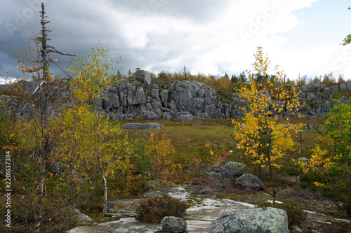 Granite cliff under a dark, dramatic sky.
