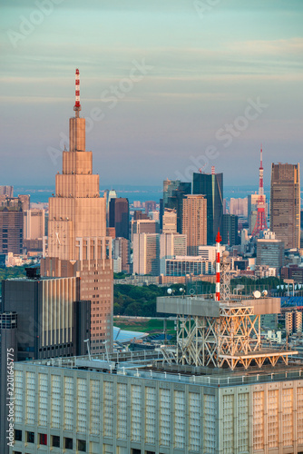 Aerial view of Tokyo Shinjuku after sunset, capturing glowing city lights, high-rise buildings, and vibrant urban streets