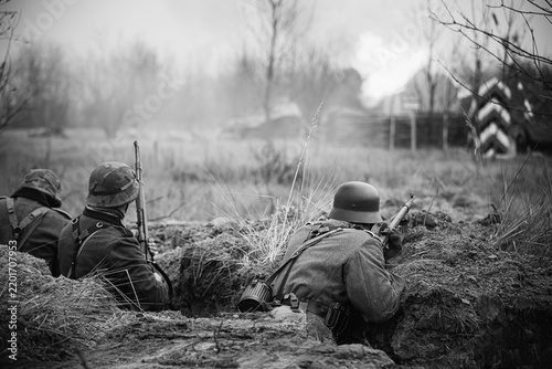 Obraz na plátně German Wehrmacht Infantry Soldiers In World War II Hidden Sitting With Rifles We
