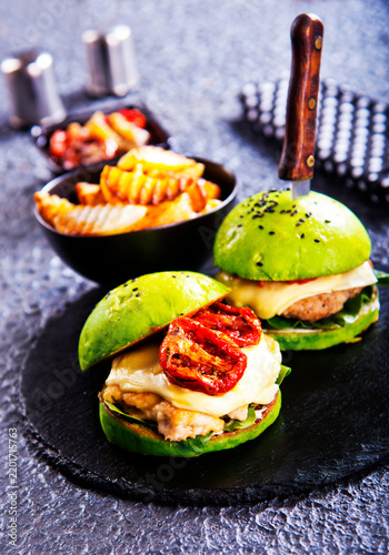 Fotografie Close-up home made burger on dark table