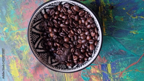 Coffee beans in a ceramic bowl. 
