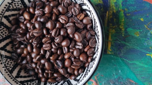 Coffee beans in a ceramic bowl. 