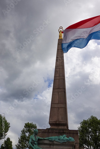 The Gëlle Frau war memorial on Place de la Constitution in Luxembourg City, featuring a tall granite obelisk topped with the famous gilded bronze statue of the Lady of Freedom.