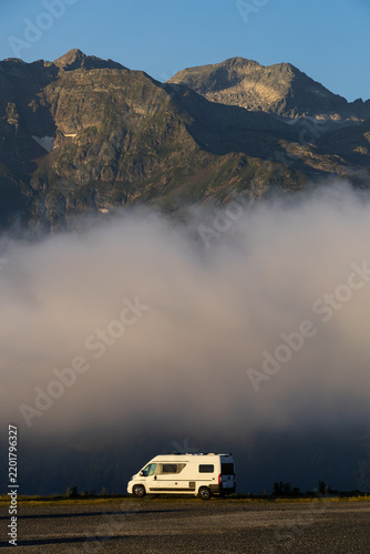 Camper van parked overlooking Superbagneres mountains at sunrise