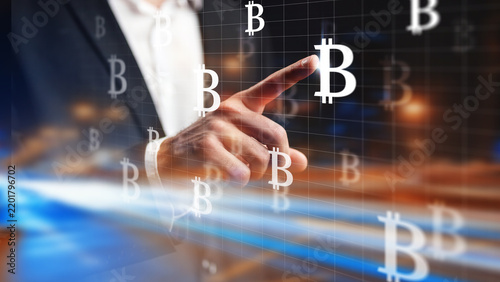 Obraz na płótnie Touching a bitcoin symbol on a digital screen during a financial event