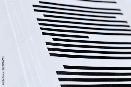 Close up of documents with fully blacked out text. Censorship secrecy and hidden information concept