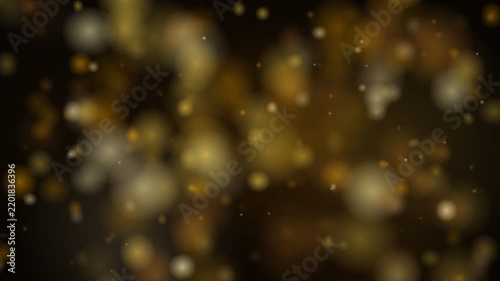 Golden bokeh particles floating on black background
