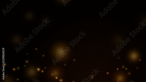 Golden bokeh particles rising on black background