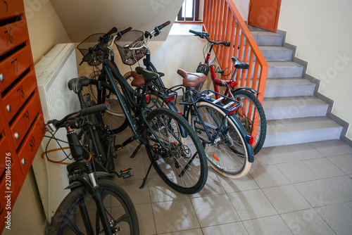 Bicycles Parked in Apartment Building Stairwell Near Mailboxes and Stairs