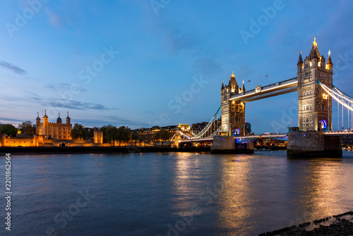 Tower bridge over Thames river and Tower of London at night, UK
