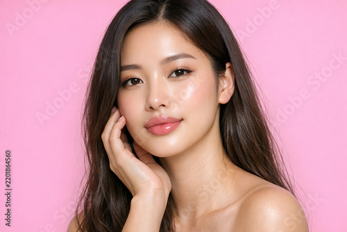 Modern portrait of a beautiful, young Korean woman with a confident smile, showcasing contemporary fashion and makeup trends.
