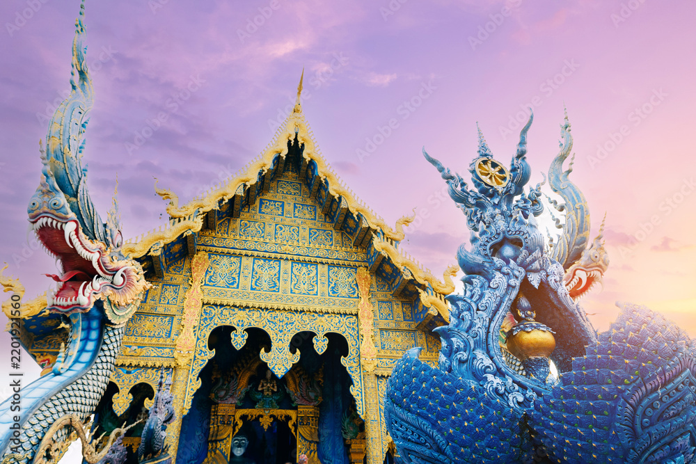 Fototapeta premium Wat Rong Suea Ten, Blue temple complex at sunset glow Chiang Rai, Thailand