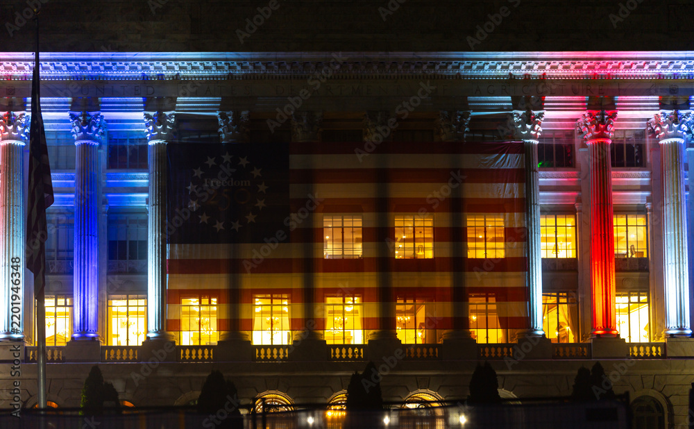 Obraz premium Agriculture building with patriotic facade. Agriculture department displays American flag. Federal lights illuminate agriculture columns. Historic architecture marks agriculture ceremony.