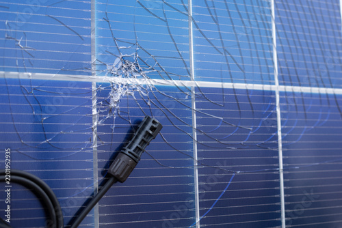 Damaged Solar Panel with Cracked Surface and Electrical Connector