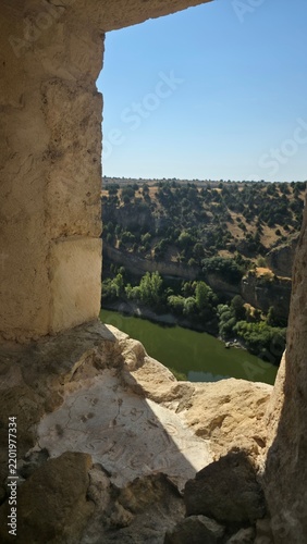 View of River and Forest Through Ancient Stone Window