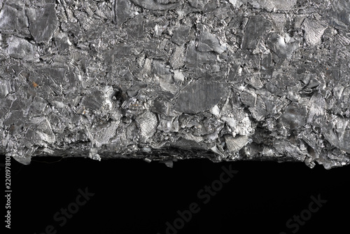 Closeup compressed block of aluminum scrap formed from processed non ferrous metal waste. Secondary raw material for metallurgical and metal processing industries