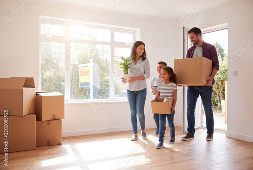 Family moves into new home with boxes and plants