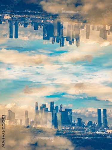 Photography Conceptual double exposure of a modern city skyline mirrored against a cloudy bl